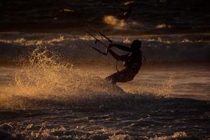 kitesurfer a puesta de sol foto