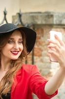 Caucasian young woman taking selfie photo