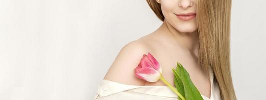 Young woman with one tulip photo