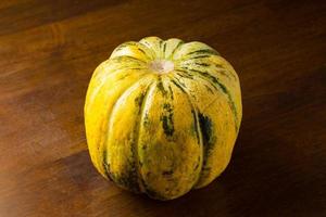 Blewah, Cantaloupe or Cucumis melo, a type of melon found in Indonesia, with a wooden background, cantaloupe is often used to make drinks during the fasting month of Ramadan photo