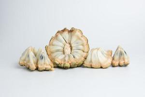 sugar apple srikaya with black spots, isolated on a white background, sugar apple fruit tastes sweet, grows in the tropics, can be eaten directly when it is ripe or can be processed first. photo