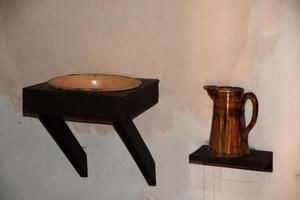 Antique basin and pitcher on a white wall photo