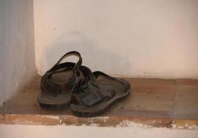 The old monk sandals in a window photo