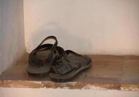 The old monk sandals in a window photo