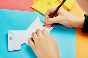 Boy making paper dog origami photo