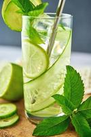 Detox refreshment drink. Lemonade with lime and cucumber photo