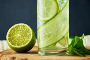 Detox refreshment drink. Lemonade with lime and cucumber photo