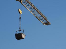 bucket attached to crane lifting hook photo