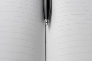 A pen placed on opened page of a book. After some edits. photo