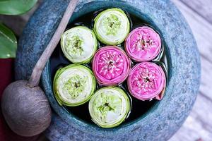 Beautiful lotus floating in a jar with water dipper photo