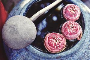 Beautiful lotus floating in a jar with water dipper photo