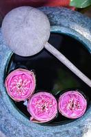 Beautiful lotus floating in a jar with water dipper photo