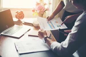 Close-up of  Team Business people discussing a financial plan at office. photo