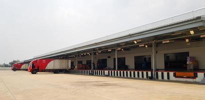 Ratchaburi, Thailand-February 27, 2023 Cargo or Warehouse for storage and transport parcel for shipping by mail and copy space. Building for distribution, Import and Export goods by red container car photo