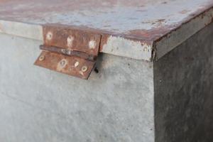 Rusty white metal gate with door hinge, close-up background photo