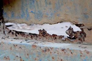 Texture old rusty corrugated metal with rotten holes photo