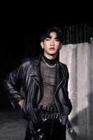an asian man in a black leather jacket posing like a motorcycle gang photo