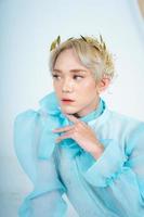 a royal princess posing with a golden crown and blonde hair very cutely photo