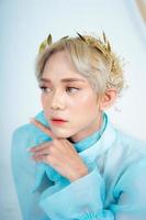 a royal princess posing with a golden crown and blonde hair very cutely photo