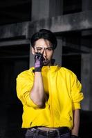 an asian man with a yellow jacket and black hair posing very gallantly photo