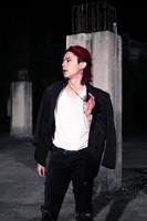a red haired asian man wearing a white t shirt and black suit photo