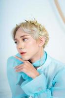 a royal princess posing with a golden crown and blonde hair very cutely photo