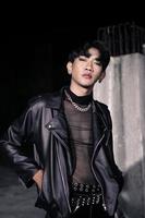 an asian man in a black leather jacket posing like a motorcycle gang photo