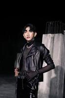 an asian man in a black leather jacket posing like a motorcycle gang photo