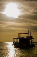 fishing boat in the sea in silhouette style photo