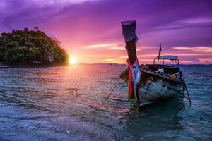 Traditional thai boats at sunset beach. photo
