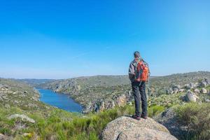 woman hiker on a rock overlooking the valley photo