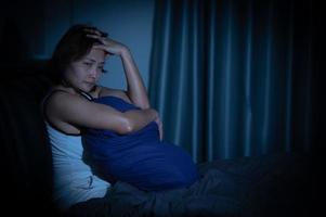 Asian women have a high concern that is why she can't sleep.Have stress from work photo