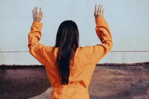 Prisoner in orange robe concept,Portrait of asian woman in Prison uniforms on white background, photo