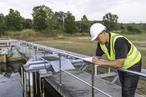 Environmental engineers work at wastewater treatment plants,Water supply engineering working at Water recycling plant for reuse photo