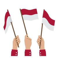 A hand holding Indonesian flag vector