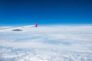 Wing of an airplane flying in the sky photo