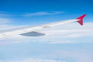 Wing of an airplane flying in the sky photo