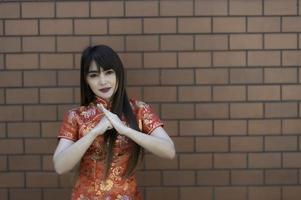 Portrait beautiful asian woman in Cheongsam dress,Thailand people,Happy Chinese new year concept,Happy asian lady in chinese traditional dress photo