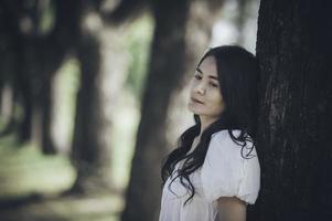 Asian beautiful girl feel alone in the forest,Sad woman concept,Thailand people,Lady sadness about love from boyfriend,She feeling broken heart photo