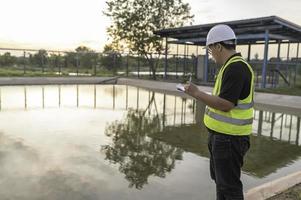 ingenieros ambientales trabajan en plantas de tratamiento de aguas residuales, ingeniería de suministro de agua que trabaja en plantas de reciclaje de agua para su reutilización foto