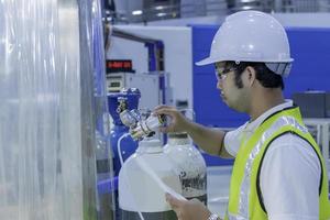 Asian engineer working at Operating hall,Thailand people wear helmet work,He worked with diligence and patience photo