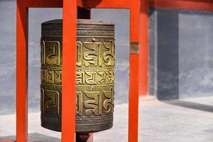 Ceremonial bell covered with tibetan inscriptions in Yonghe Temple also known as Palace of Peace and Harmony Lama Temple or simply Lama Temple in Beijing, china photo