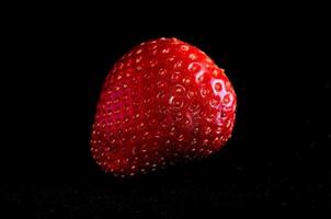 Strawberry on black background photo