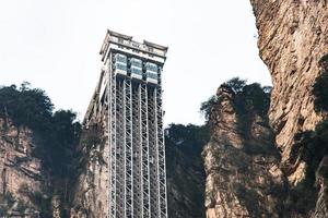 ZHANGJIAJIE CHINA - FEB 29, 2016- Bailong Elevator is a glass elevator built onto the side of a huge cliff in the Wulingyuan area of Zhangjiajie, China that is 1,070 feet high. photo