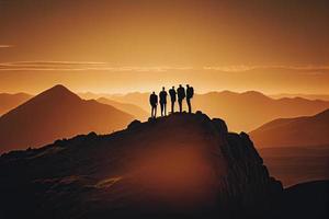 Team success concept photo, friends standing together on the top of the hill, over beautiful mountains landscape in gold sunset light photo