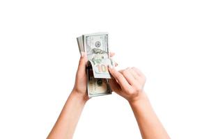 Isolated image of female hands counting dollars on white background. Top view of salary and wages concept photo