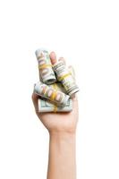 Top view of rolled up in tubes dollar bills in female palm on white isolated background. Poverty and debt concept with empty space for your design photo