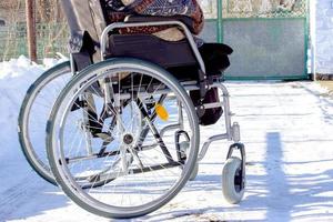 Adult man in wheelchair. Close up photo of male hand on wheel