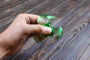 Hands holding popular fidget spinner toy. fidgeting spinner photo