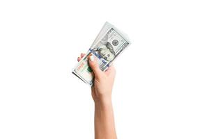 Female hand giving a bundle of dollar bills on white isolated background. Top view of power and wealth concept photo